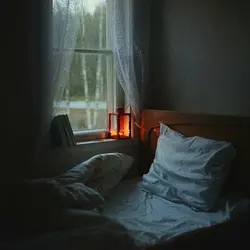 Photo of a bedroom at night with a window