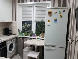 Corner kitchen refrigerator by the window photo