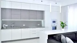 Photo of white kitchen with gray appliances