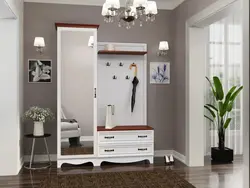 Coat rack in a small hallway with a mirror photo