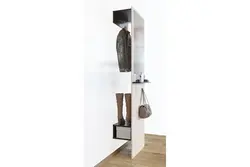 Coat rack in a small hallway with a mirror photo