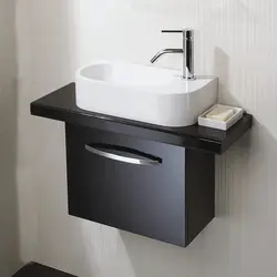 Small bathroom sink with cabinet photo