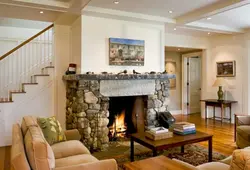 Photo of the living room interior with a fireplace and staircase