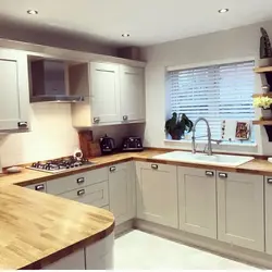 Cream kitchen with wooden countertop and apron photo