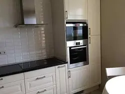 Photo of a kitchen with a pencil case for an oven and microwave