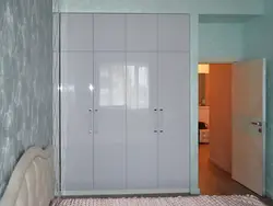 Wardrobe with hinged doors and mirror in the bedroom photo