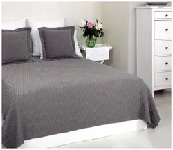 Gray bedspread in the bedroom interior