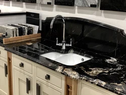 Black marble countertop in the kitchen interior