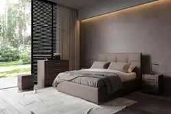 Beige bed with a soft headboard in the bedroom interior