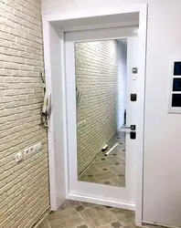 Door with a mirror in the interior of a small entrance hallway