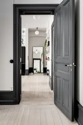 Doors in the interior of an apartment with gray floors