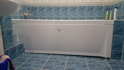 Photo of the bathtub covered with tiles