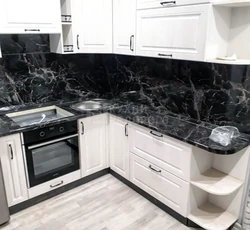 Kitchen with black marble countertop photo