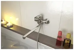 Bathtub and faucets with long photo