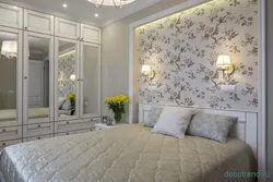 Photo of a bedroom with flowers at the headboard