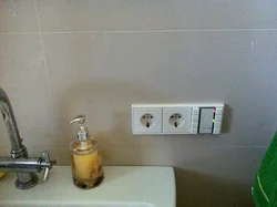 Socket and switch in the bathroom photo