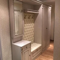 Photo of hallway cabinets with shoe rack and seat