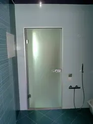 Glass doors to the bathroom and toilet photo