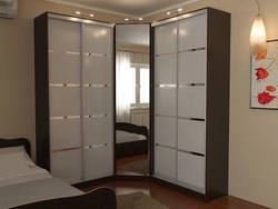 Corner Wardrobe In The Bedroom With Mirrors And Drawers Photo