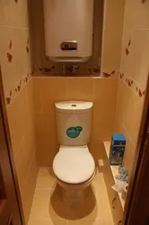 Photo of a toilet in an apartment with a boiler