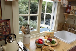 Kitchen in a wooden house with a sink by the window photo