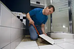 Laying Tiles In An Apartment Photo