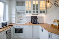 White kitchen with wooden countertop photo