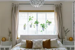 Bed by the window in the bedroom interior photo