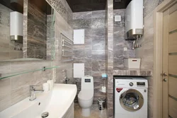 Bathroom interior with toilet and small washing machine