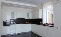 White glossy kitchen with black countertop photo