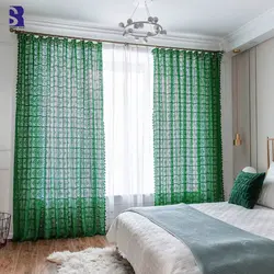 Green curtains in the bedroom interior