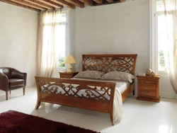 Wooden bed in the bedroom interior photo