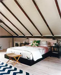 Bedroom design with a sloping ceiling in a wooden house