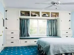 Bedroom design with wardrobe around window