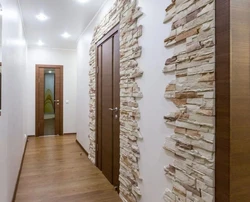 Decorative stone in the interior with hallway wallpaper