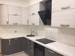 White-gray corner kitchen in the interior