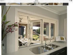 Kitchen design with a window and access to the terrace photo