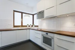 White corner kitchen with wooden countertop photo