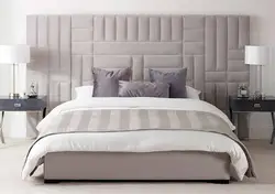 Photo of a bedroom with a soft headboard