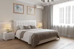 Photo of a bedroom with a soft headboard