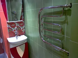 Heated towel rail in the bathroom interior