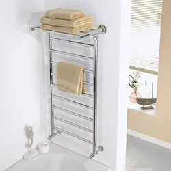 Heated towel rail in the bathroom interior