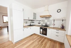 Wallpaper in the interior of a white kitchen with wood