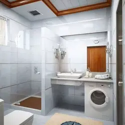 Bathroom interior with small bathtub and washing machine