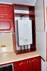 Photo Of A Kitchen With A Gas Boiler On The Wall And Pipes