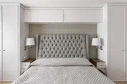 Wardrobes above the bed in the bedroom photo