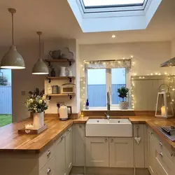 Kitchen design in a modern style with a window in the middle photo