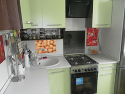 Kitchen design in an apartment with a gas stove and refrigerator