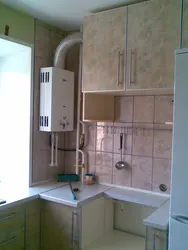 Kitchens in Khrushchev with a gas water heater and a refrigerator photo