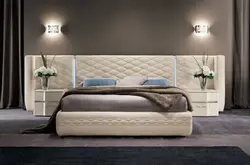 Bedroom design with a bed with a soft headboard